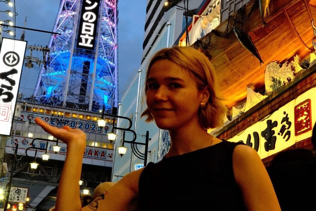 Anastasiya on a neon-lit Osaka street at dusk